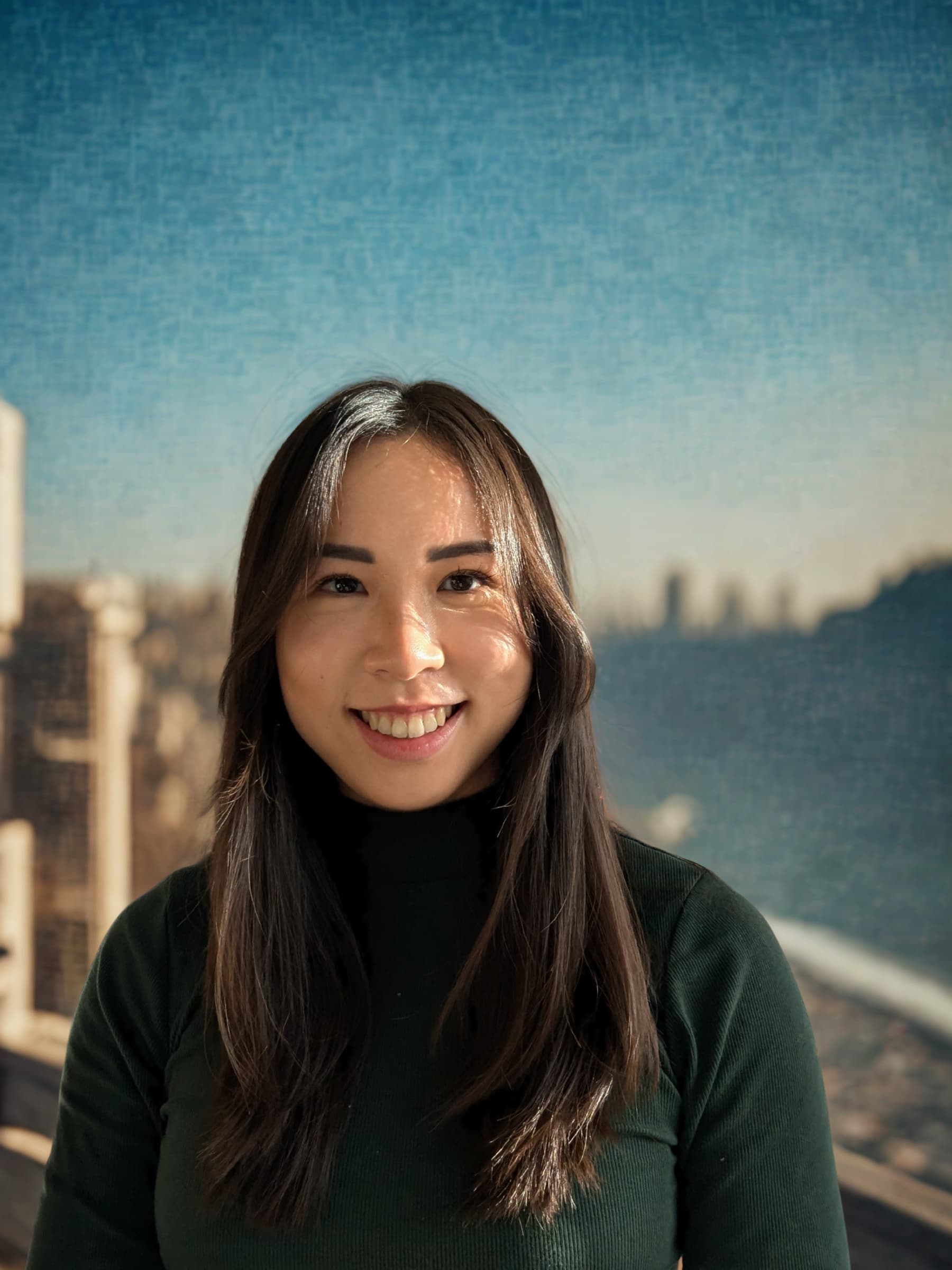 Portrait of Leah Zou against a blue cityscape backdrop