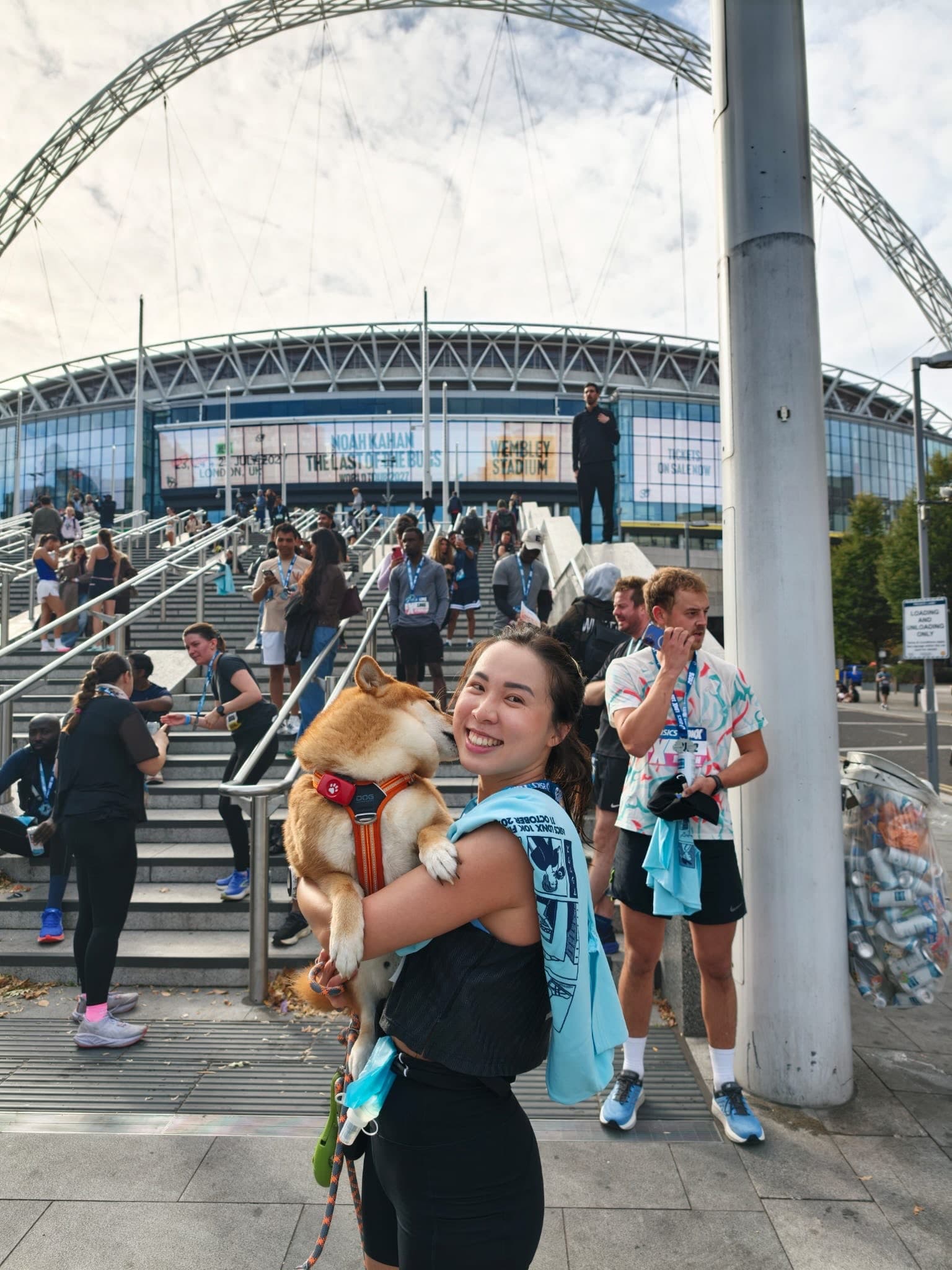 Leah holding her dog outside Wembley Stadium after the ASICS LDNX 10K
